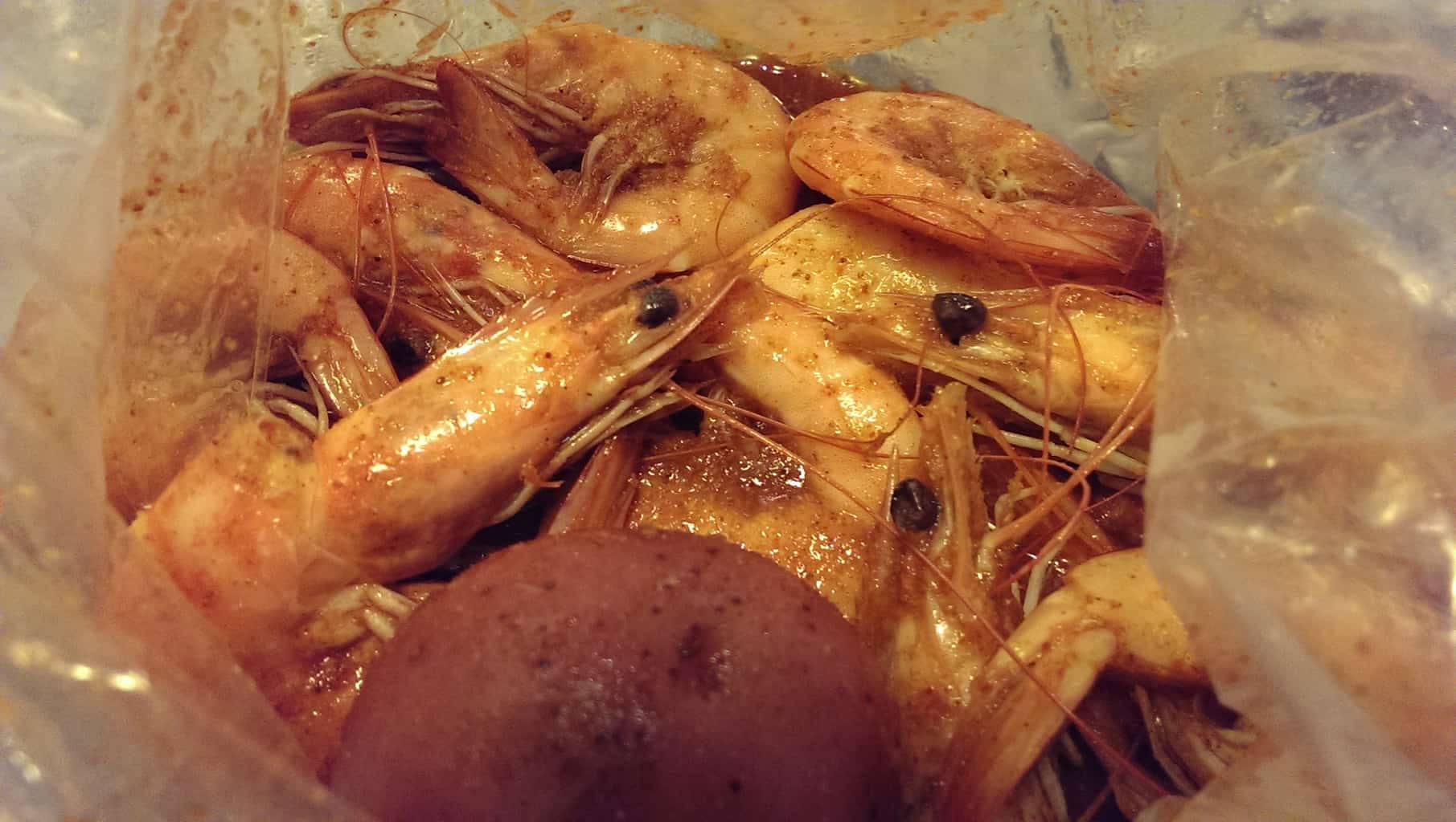 shrimps with juicy cajun seasoning with corn and potatoes